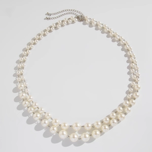 Detail of double-layer faux pearl necklace with silver chain and lobster clasp