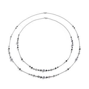 Close-up of pearl layered long necklace with silver star pendants and beads details