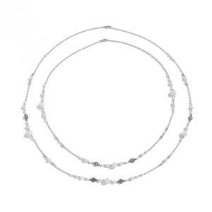 Detail of silver long necklaces with faux pearls, star tassels and lobster clasp closure
