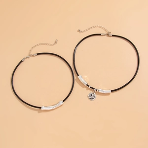 Detail of retro double-layer choker with silver relief coin pendant and curved metal tubes