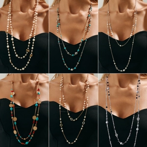 Bohemian multi-layer long necklaces with faux pearls and star pendants shown on model