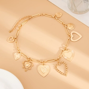 Detailed view of a gold chunky chain necklace featuring eight diverse heart pendants