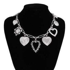 Detailed macro view of silver alloy chain necklace with multiple heart pendants