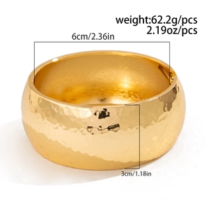 Detail view of golden textured cuff bracelet with precise size and weight annotations