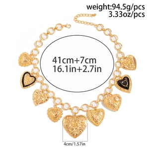 Detail of chunky gold chain necklace with heart pendants and adjustable lobster clasp