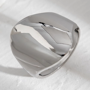 Detailed close-up of a wide chunky silver dome ring with a polished mirror finish surface