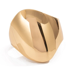 Detailed close-up of chunky gold-toned geometric cuff with a mirror-polished finish