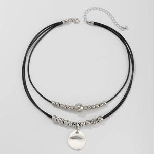 Detail view of double-layer choker with metallic beads and smooth round pendant