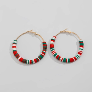 Detailed macro view of gold hoop earrings with red, white, and green heishi beads