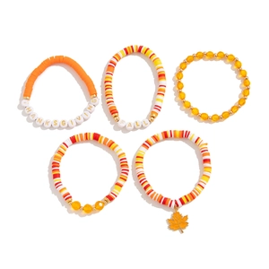 Close-up of Thanksgiving 5-piece beaded bracelet set with maple leaf charm and FALL letters