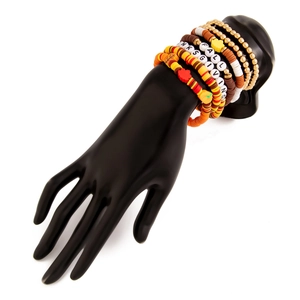 Detailed view of layered Thanksgiving bracelets featuring pumpkin charms and FALL beads