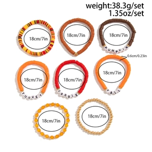 Close-up of Thanksgiving beaded bracelets with PUMPKIN and FALL charms in autumn colors