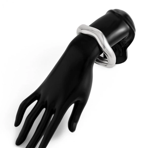 Detailed view of silver polished wavy metal bracelet featuring a smooth reflective surface