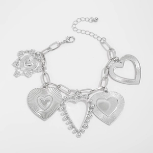 Detail view of silver chain bracelet with five unique textured heart-shaped pendants