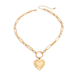 Detail of gold lava heart pendant with layered textures and sturdy rectangular link chain