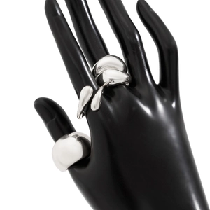 Vue détaillée des bagues gouttes d'argent polies au design organique sur une main noire