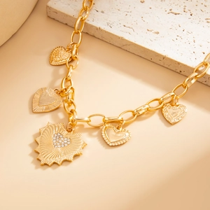 Detail of a golden lava heart necklace featuring sunburst texture and sparkling crystals