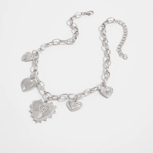 Close-up of silver metal chain featuring five unique lava heart charms with various textures