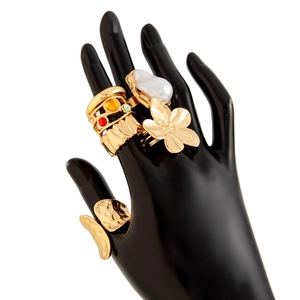 Close-up of golden lava flower rings with baroque pearls and multicolored gemstones