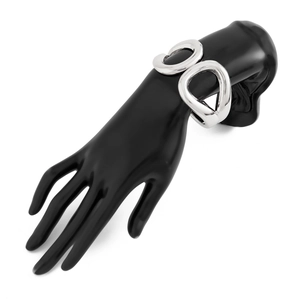 Close-up of polished silver open cuff bracelet with dual hollow ring design on model hand