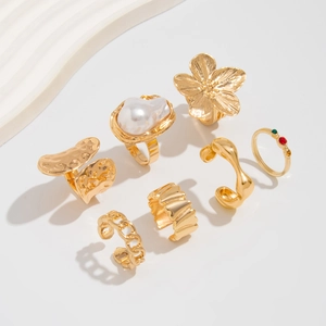 Close-up of gold lava flower ring set with irregular pearls and gemstones