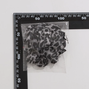 Dettaglio di un choker in tessuto leopardato con misurazioni delle dimensioni su scala