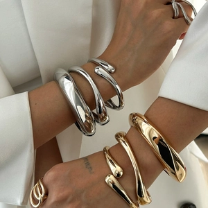 Gepolijste metalen armbanden en ringen set met minimalistisch vloeiend ontwerp voor dames