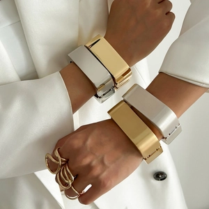 Modern metallic spring bangles and twist rings in polished gold and silver finishes