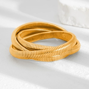 Detail of three-layer gold-plated Tubogas snake bracelet with polished metallic finish