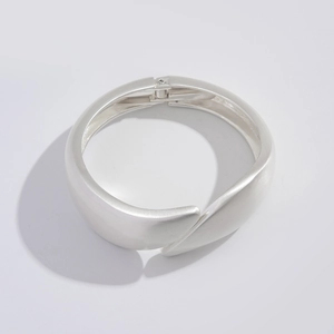 Detail of matte silver cuff bracelet with unique diagonal overlapping wrap design