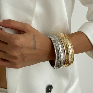 Hammered metal wide open bangles in gold and silver finish set on fashion model