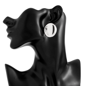 Polished silver oval stud earrings shown on black mannequin for realistic size comparison