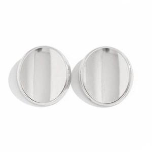 Macro view of minimalist polished silver bow earrings with smooth mirror finish texture