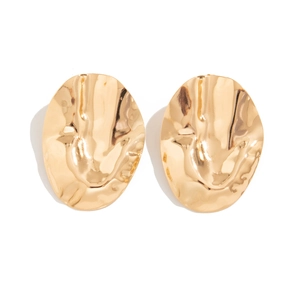 Detail view of irregular golden metal stud earrings with textured pleated surface finish