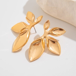 Detailed view of golden textured petal earrings with a polished metallic finish
