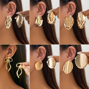 Golden oversized geometric stud earrings featuring wavy textures and bow designs in a set