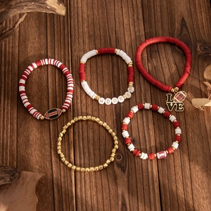 Detail of 5-piece red and white beaded bracelet set with football and LOVE charms