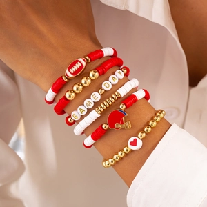 Detail of multi-layer beaded bracelets with football charms and Game Day lettering