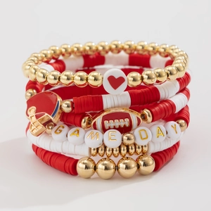 Detail of Game Day beaded bracelets featuring rugby helmet charms and red heart beads