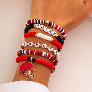 Detail view of multi-layer beaded rugby bracelets with letters and football helmet charm