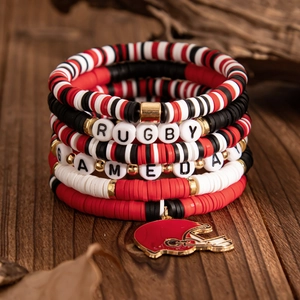Detail of five-piece rugby beaded bracelet set with GAMEDAY letters and helmet charm