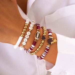 Detail of five-piece Game Day beaded bracelet set with rugby charms and clay beads