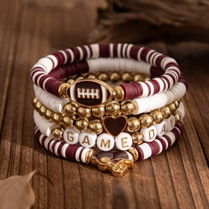 Macro detail of 5-piece Game Day beaded bracelet set with rugby and helmet charms
