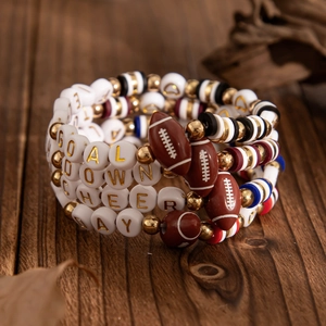 Detail of four-piece American football beaded bracelets with sports goal letters