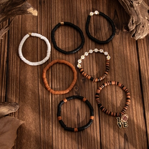 Detail view of 7-piece Heishi bead bracelets with GAMEDAY lettering and rugby charm