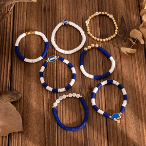 Detail of 7-piece Game Day beaded bracelet set with navy Heishi clay and football charms