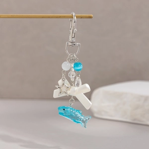 Detailed macro view of blue whale shark pendant with white bow and star beads
