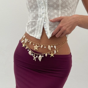 Detail view of Bohemian gold waist chain with shell, starfish and pearl charms