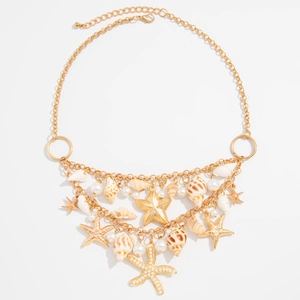 Bohemian gold layered necklace featuring sea shells, starfish pendants, and pearls