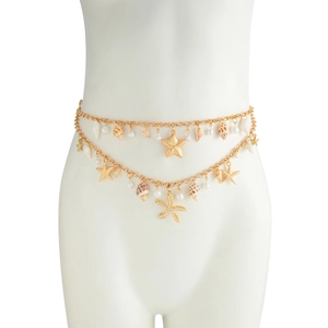 Detail of layered gold waist chain featuring seashells, starfish pendants, and pearls